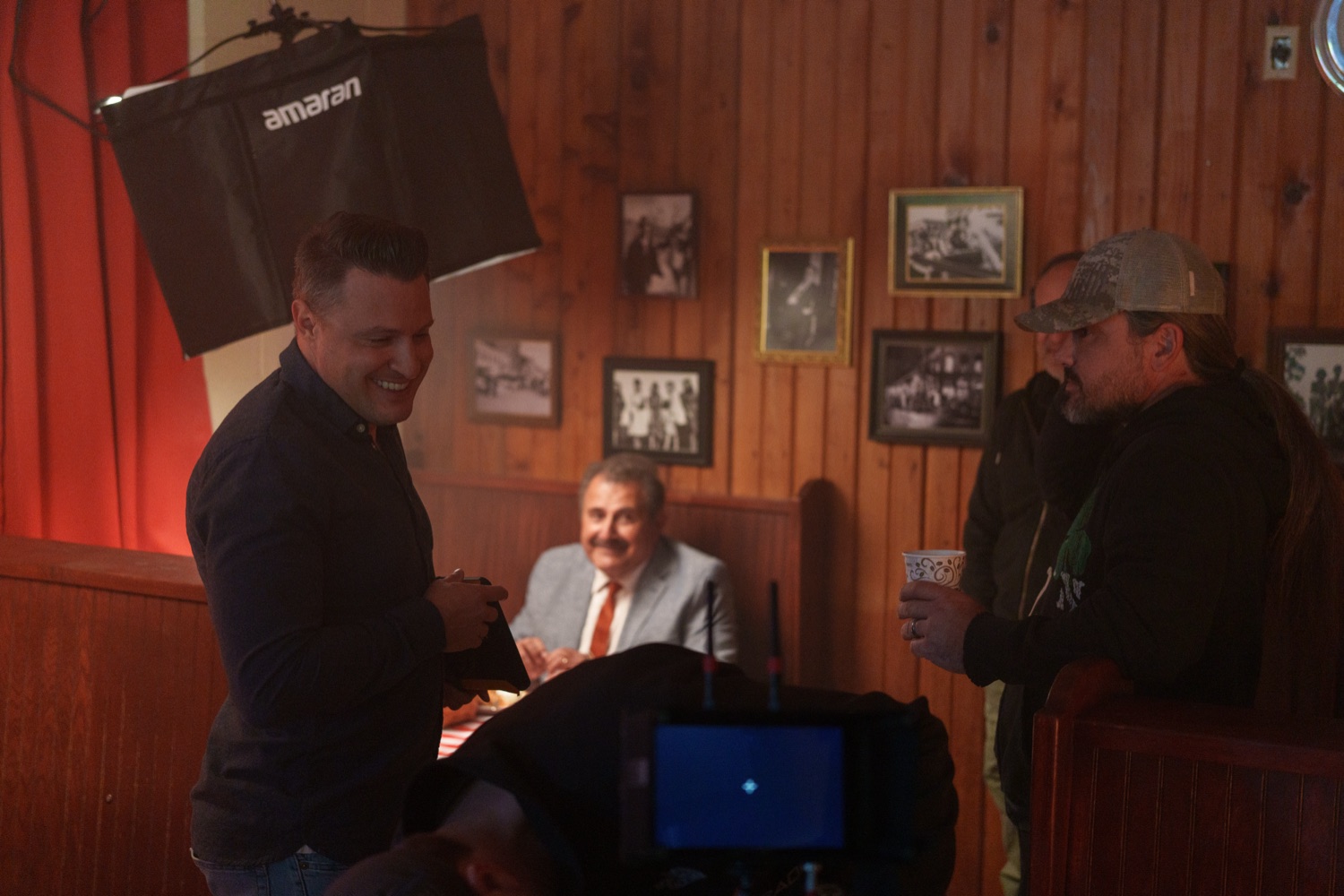 Jonathan Coussens laughing with crew between setups.