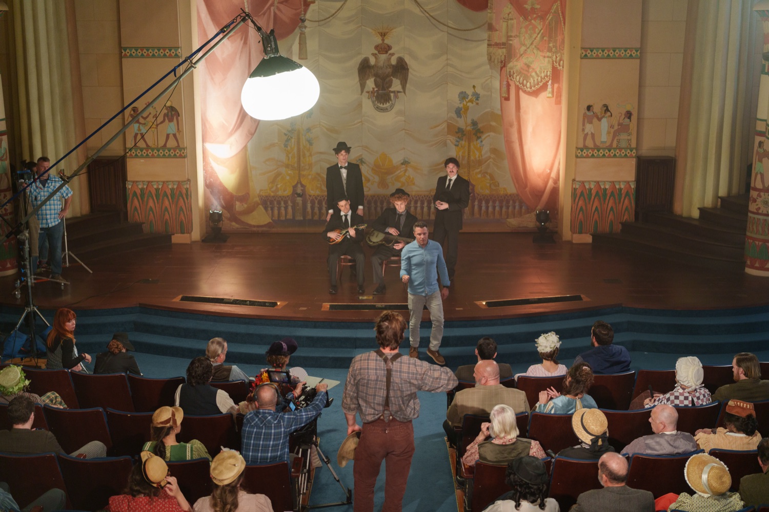 Jonathan Coussens directing a theater crowd scene.