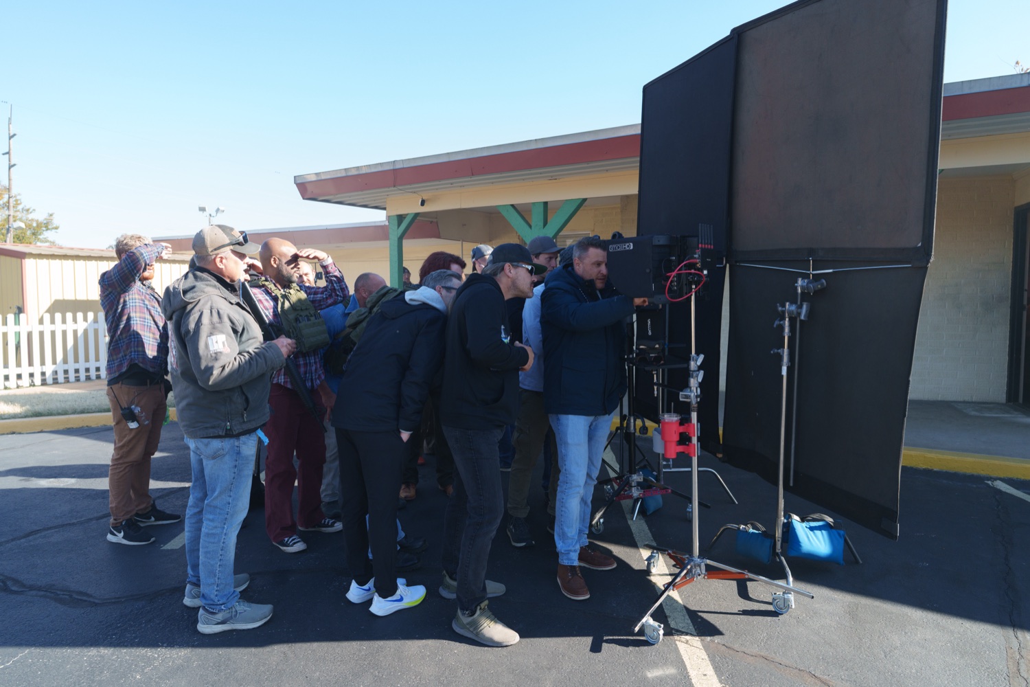 Jonathan Coussens with the crew on a daylight exterior setup.