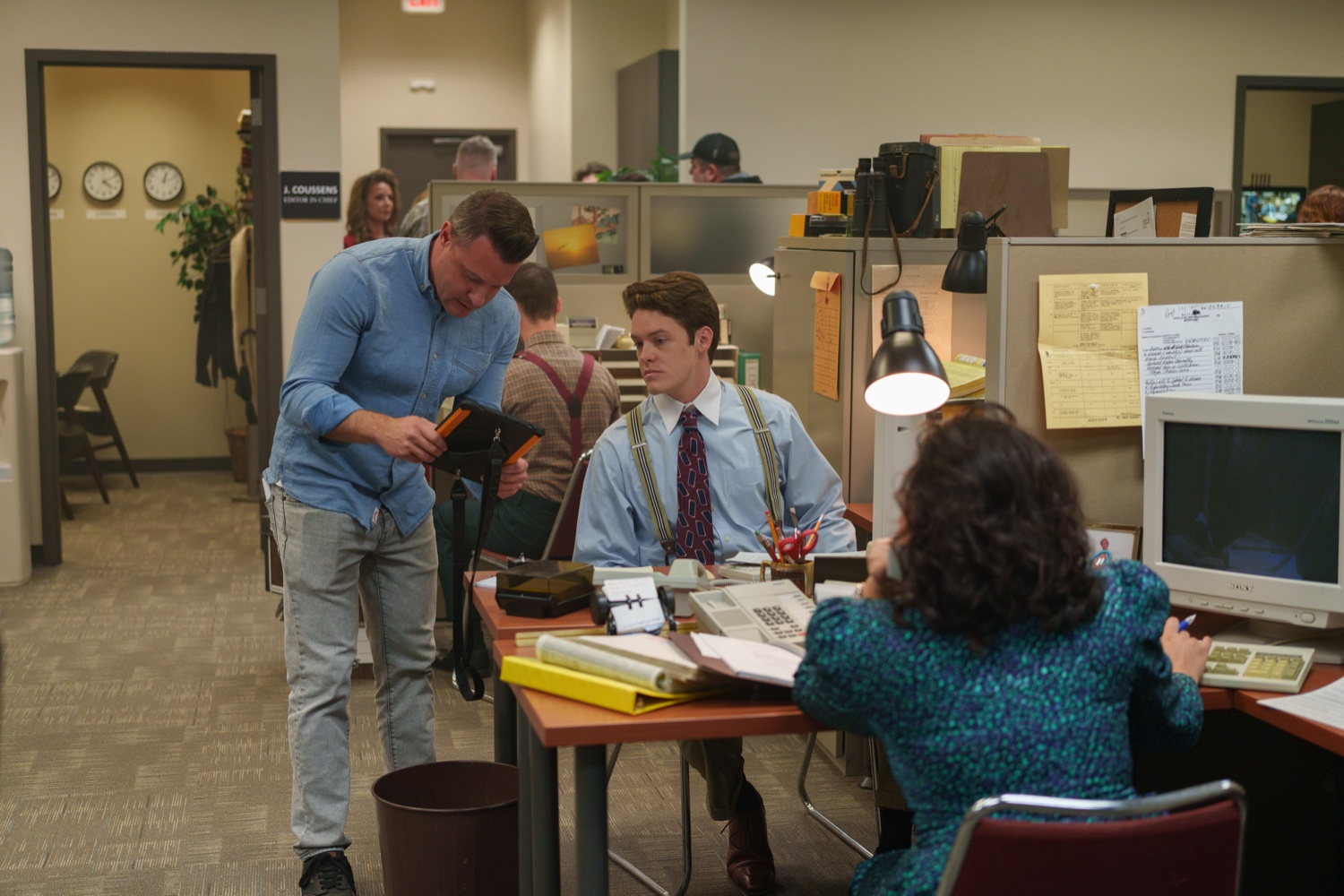 Directing a scene in a period office set.